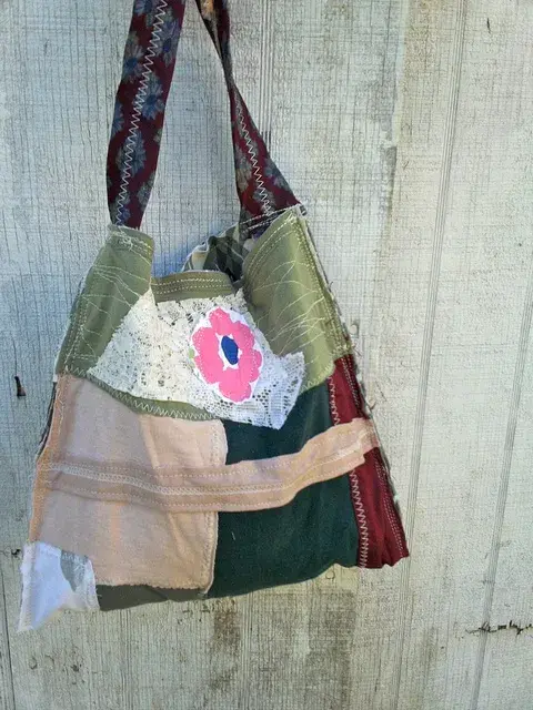 Patchwork fabric bag with patterned handle.