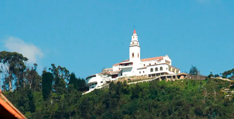 White Monserrate Sanctuary at the top of a green mountain.
