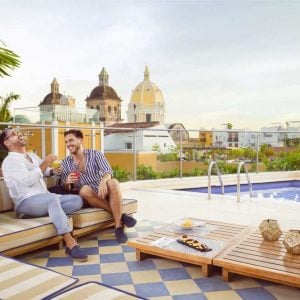 Two guys enjoy the sun from a rooftop in Cartagena. Discover the LGBT history of Colombia