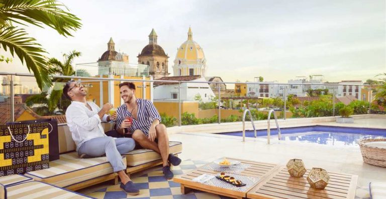 Two guys enjoy the sun from a rooftop in Cartagena. Discover the LGBT history of Colombia