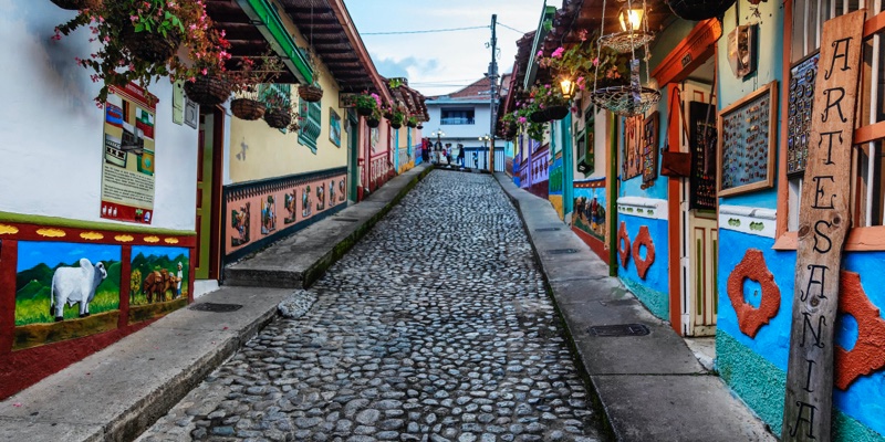 View of the colorful houses in Guatapé, a place where you can visit coffee farms nearby.