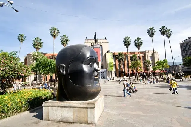 Colombia temperate zone, square with monument accompanied with trees and people, medellín, botero, plazoleta de botero