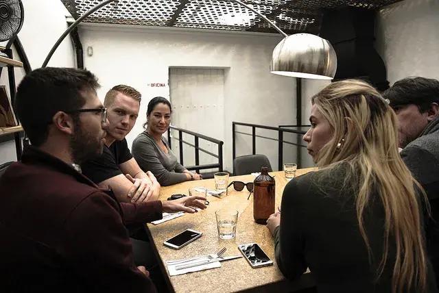 Group of friends conversing in a restaurant in Bogotá.