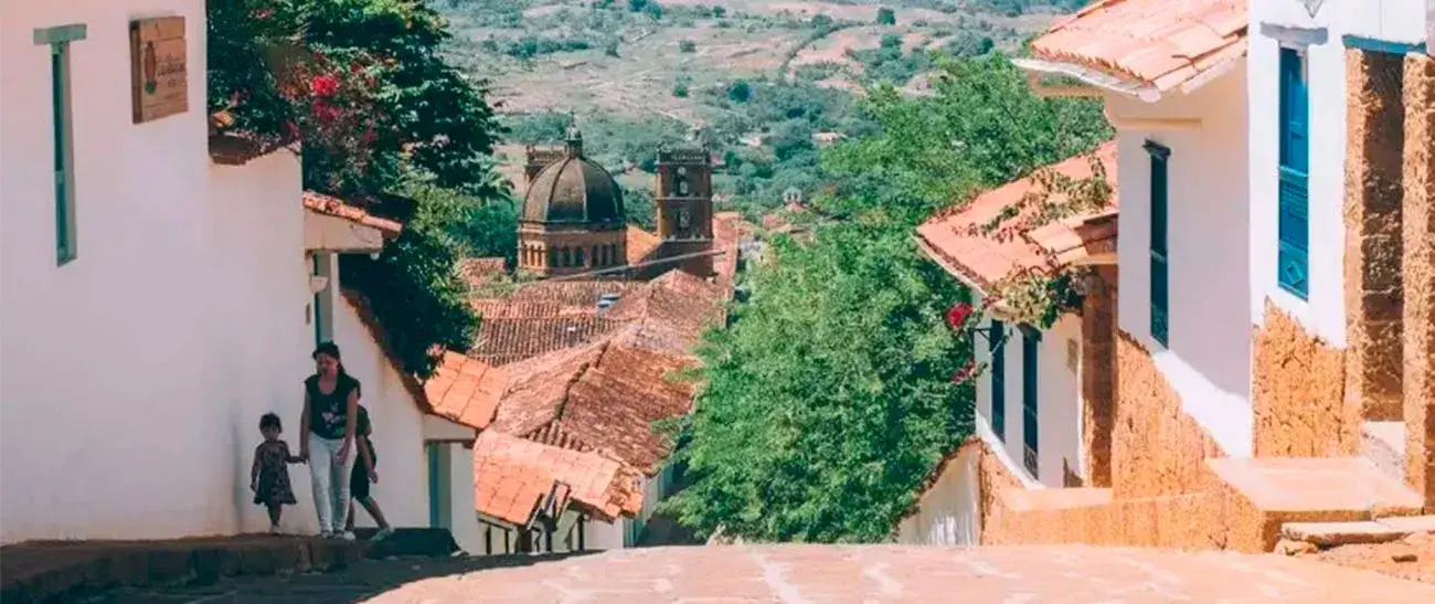 Calle Real in Barichara with colonial houses featuring white facades and tiled roofs