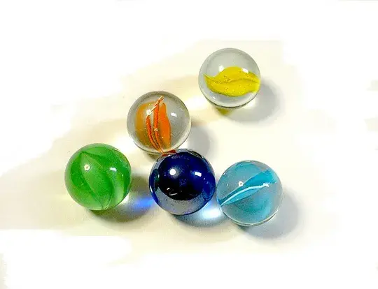 Five colored marbles on a white background.
