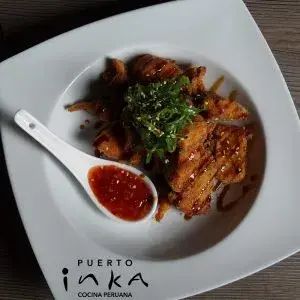 Salmon crackling dish served with sauce at Puerto Inka restaurant.