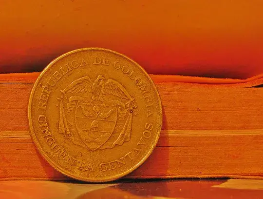 Colombian 50 centavos coin on a book.