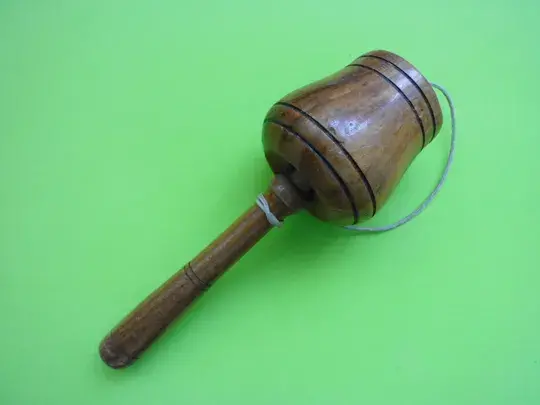 Wooden ball on green background.