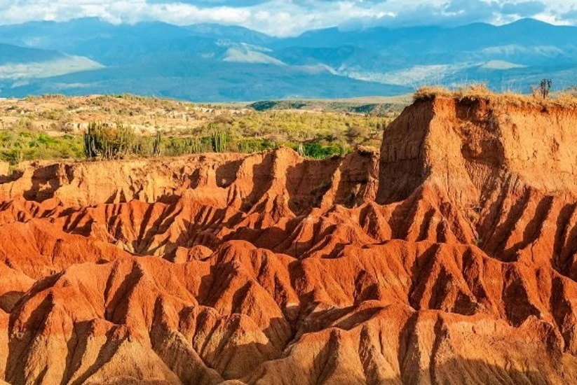 Desierto de la Tatacoa in Colombia, with a blue sky and green ecosystem around