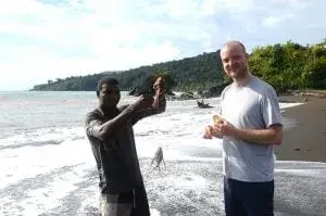 Men on Colombian Pacific beach showing off freshly caught fish
