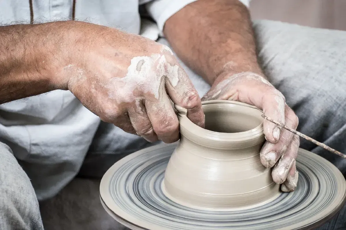 Hands creating ceramic art