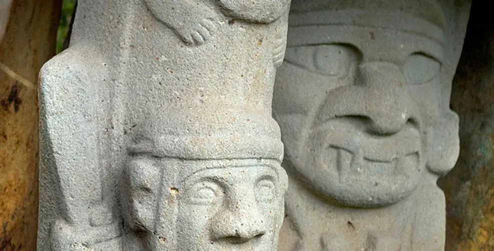 Pre-Columbian stone sculptures with carved faces in San Agustín Archaeological Park.