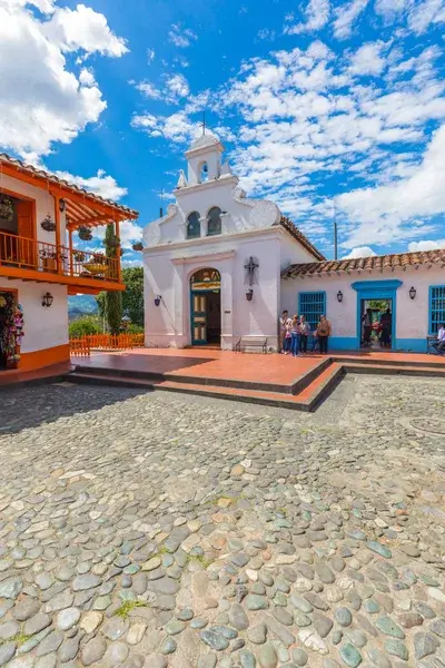 Traditional church in Medellin's Pueblito Paisa under a blue sky.