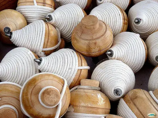 Wooden tops with white rope.