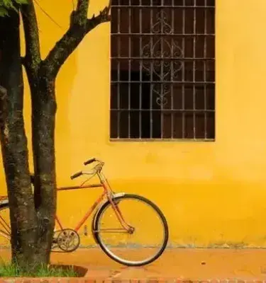 Bicycle next to yellow wall on colonial street Bicycle next to yellow wall on colonial street