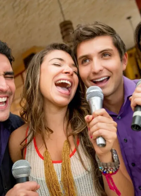 La amistad de colombianos divirtiéndose mientras cantan karaoke juntos|5 características de la amistad de un colombiano. jovenes cantando