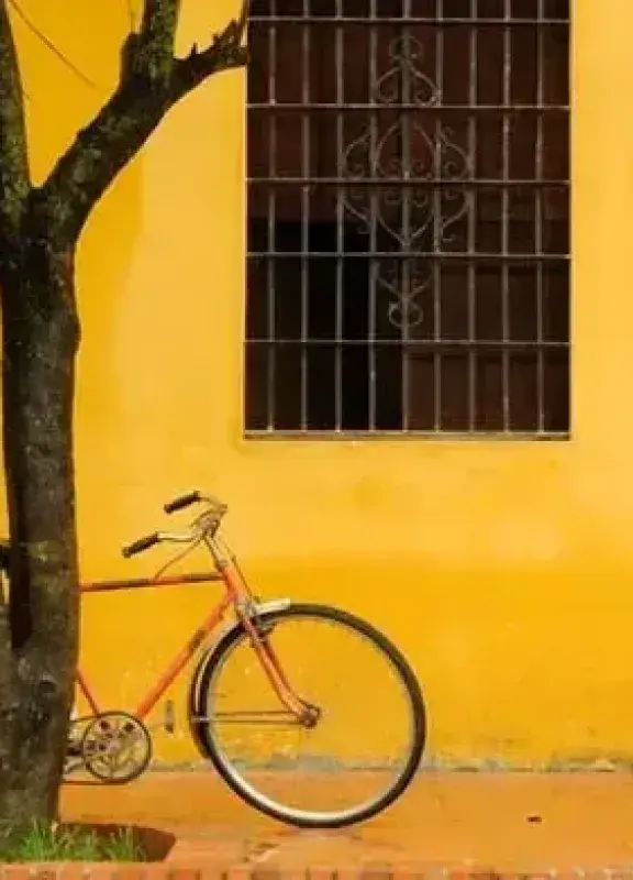 Bicycle next to yellow wall on colonial street Bicycle next to yellow wall on colonial street